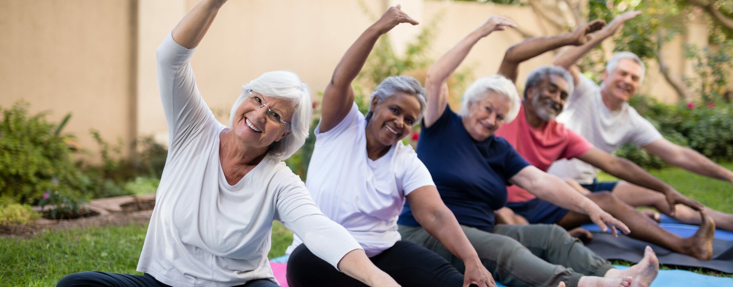 A group of seniors practicing yoga outdoor