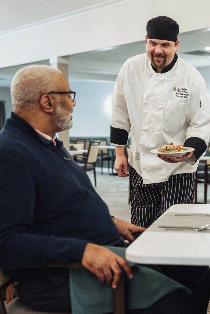 TCC STAFF CHEF SERVING FOOD