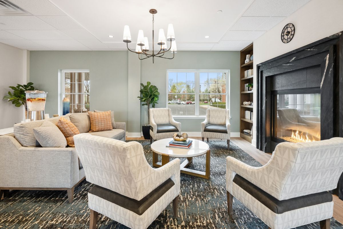 Cozy chairs and a crackling fire create a comfortable and welcoming atmosphere at Arbour Square of Harleysville PA Senior Living Community.