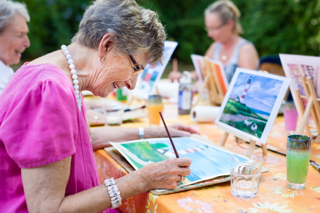 happy seniors painting outdoors