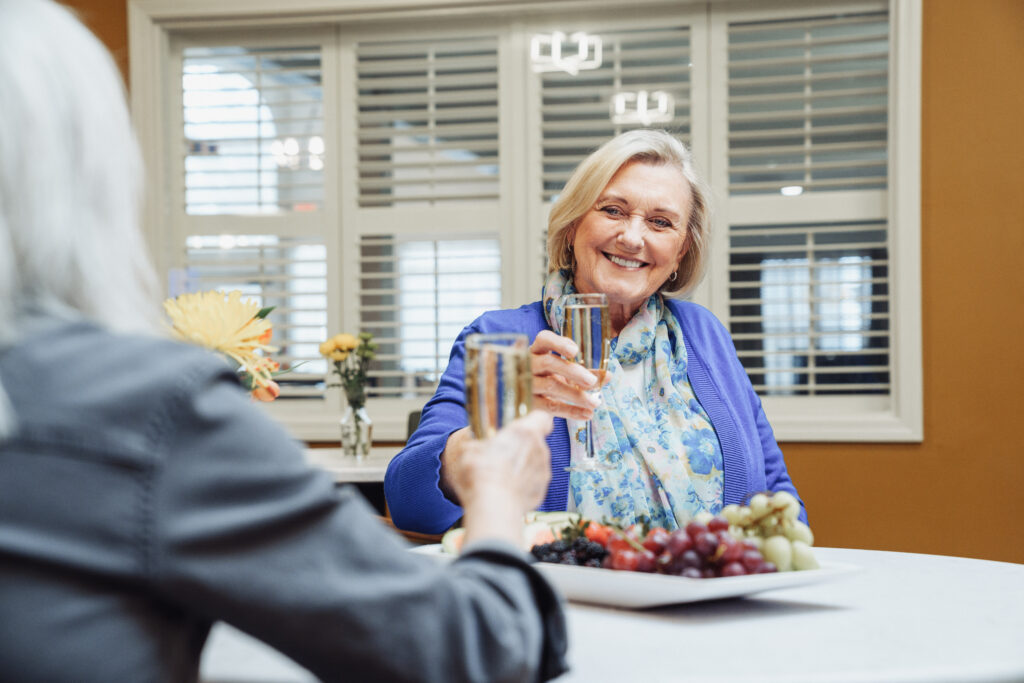 Senior Women Drinking Champagne during a Family Visit at True Connection Communities