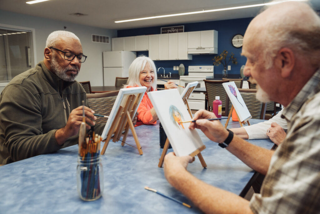 Seniors Painting during a Family Visit at True Connection Communities