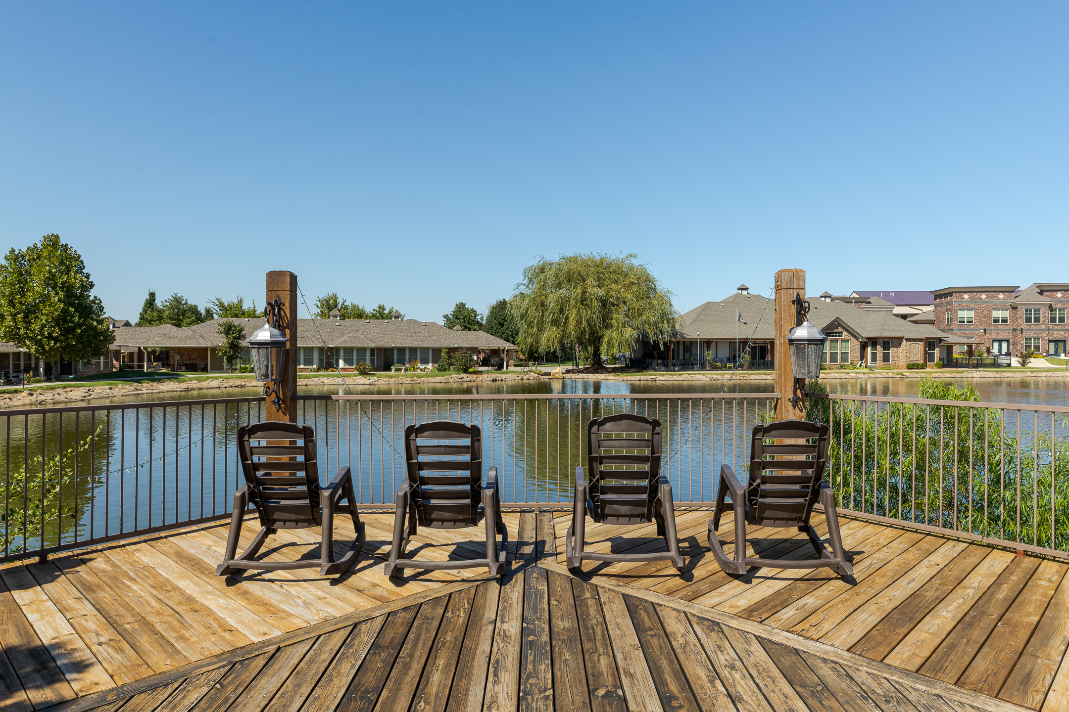 A spacious dock floats over a stunning lake and has seating available at Grace Pointe Senior Living Community in Oklahoma.