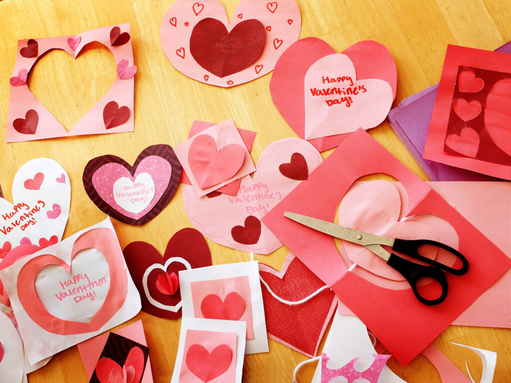 Homemade Valentines Hearts and Cards on Table with Scissors valentines day activities for seniors