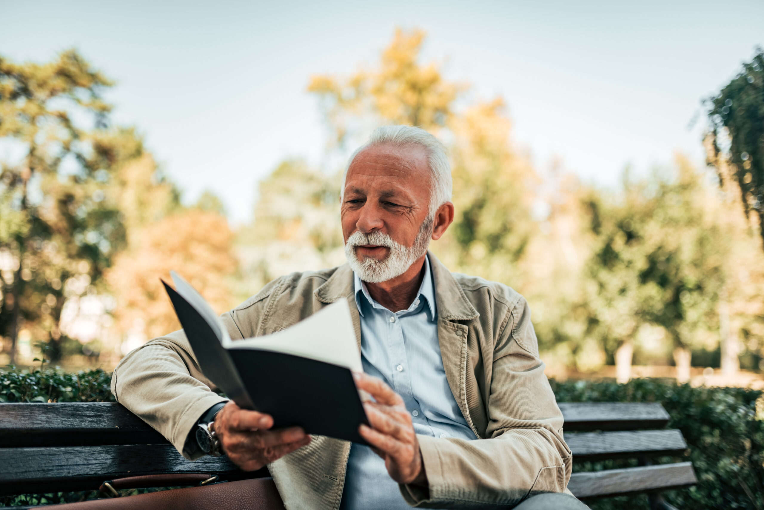 man reading a book club for seniors
