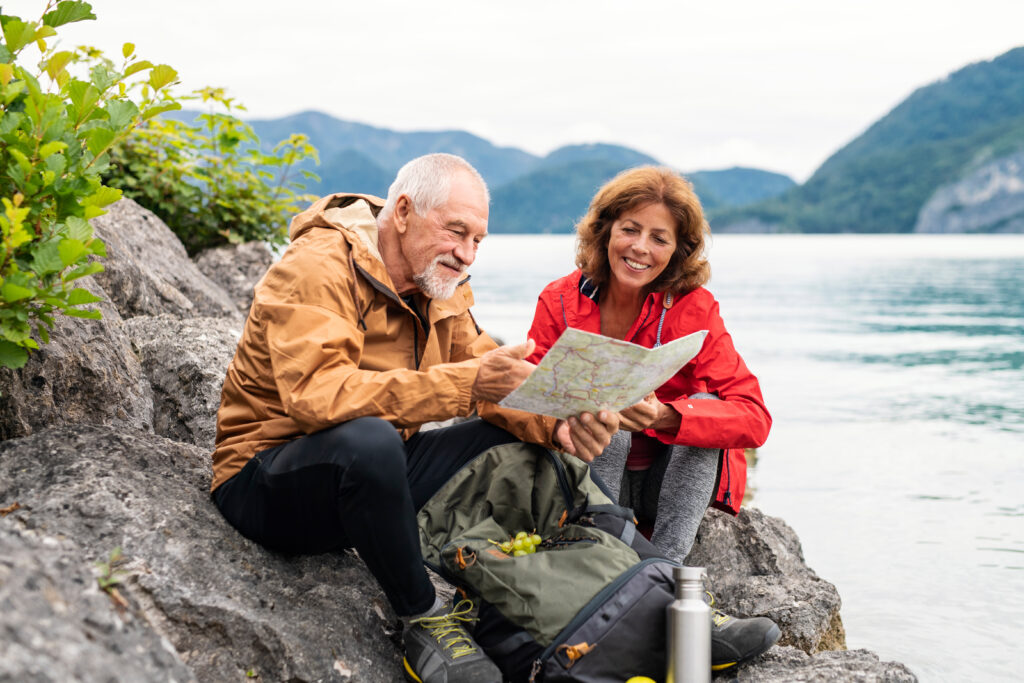 Travel Tips for Seniors reviewing a map at the lake