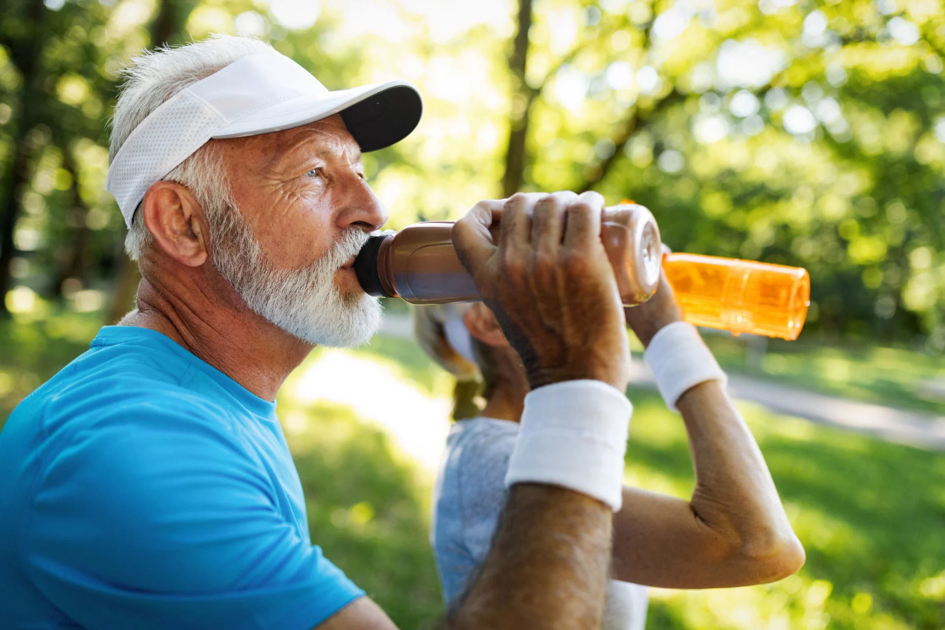 Closeup portrait, thirsty senior mature man drinking water outside