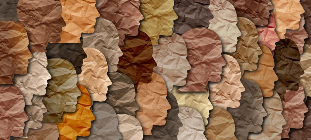 Abstract collage of overlapping paper face silhouettes in warm earth tones and shades of brown