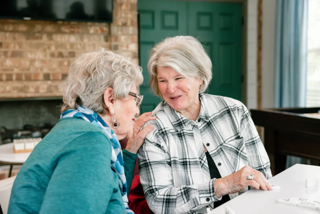 Mon Abri friends sharing a laugh while playing dominoes