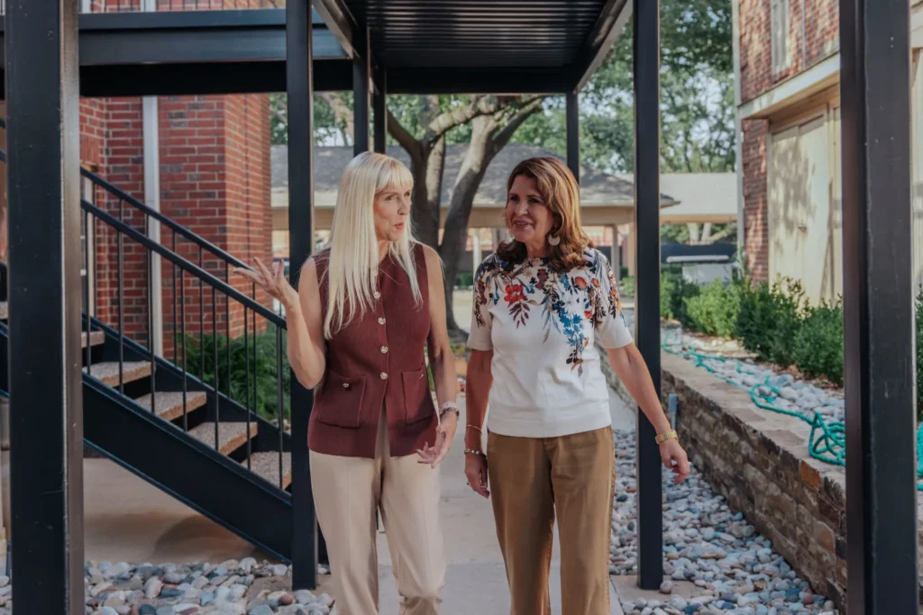 The Oaks at Plano residents walking on a path outside the apartments