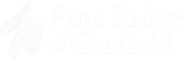 Pine Ridge of Garfield logo in white with a pinecone icon