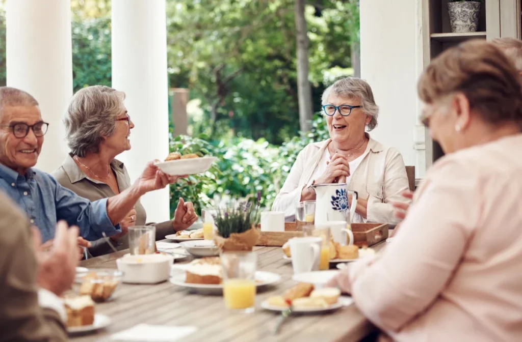Group of seniors enjoying breakfast together on a patio