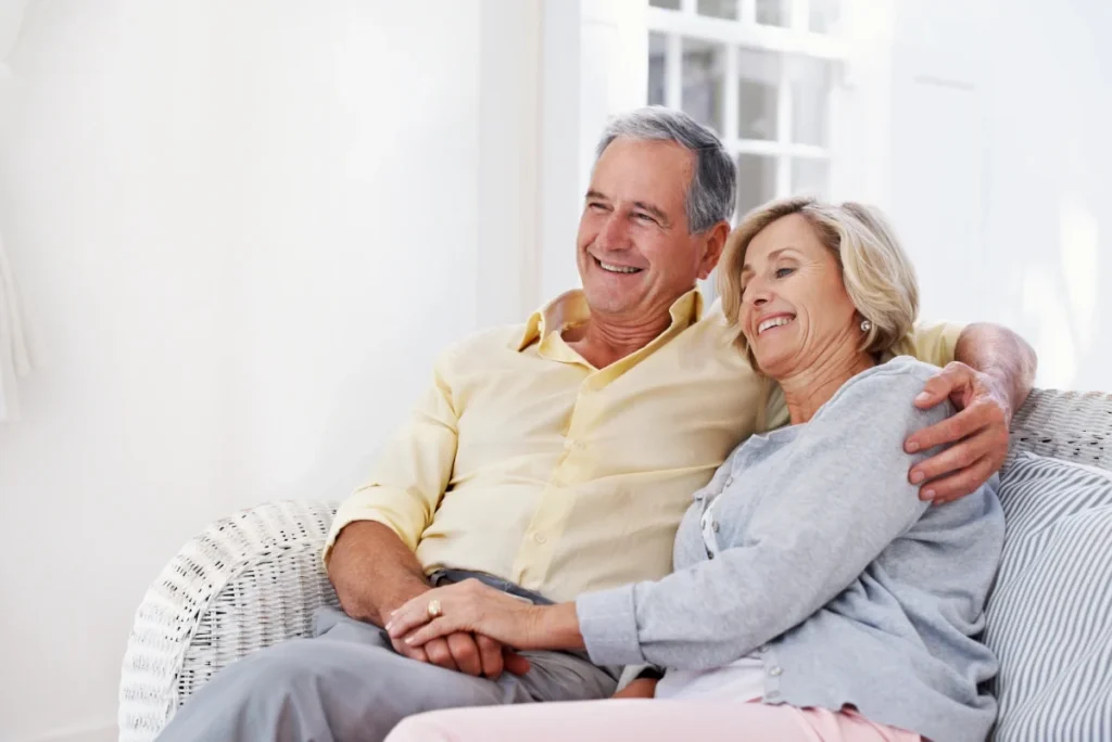 Senior couple smiling and holding hands together