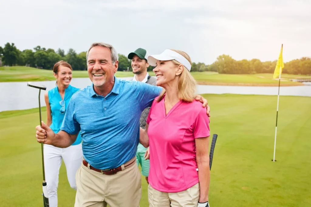 Senior friends laughing together on a golf course