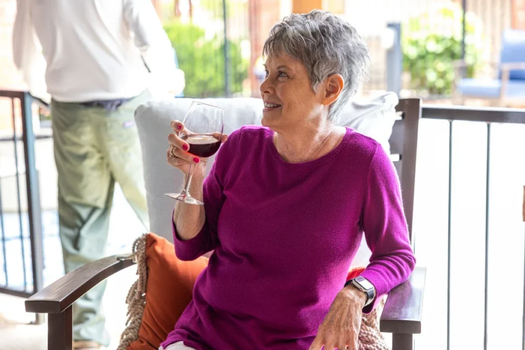 Senior woman drinking wine on porch