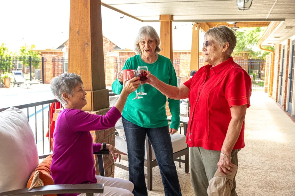Senior women toasting on a porch
