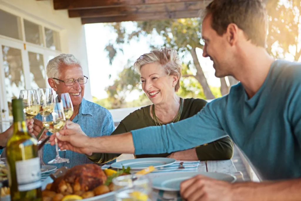 Family toasting with drinks together at an outdoor patio lunch