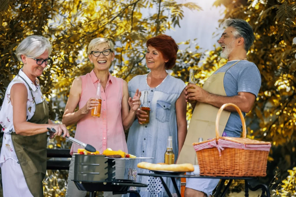 Group of seniors grilling outside together