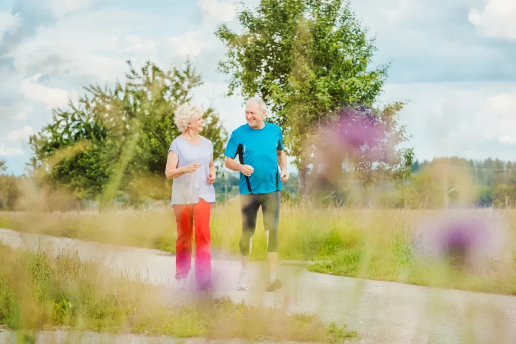 Senior couple jogging together outdoors