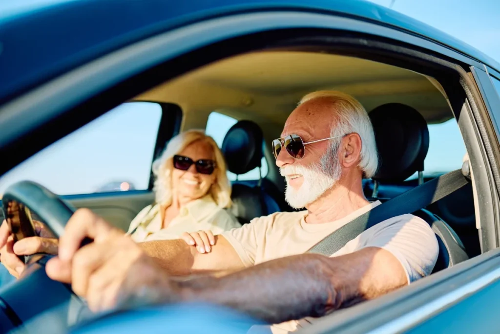 Senior couple enjoying a road trip together in their car