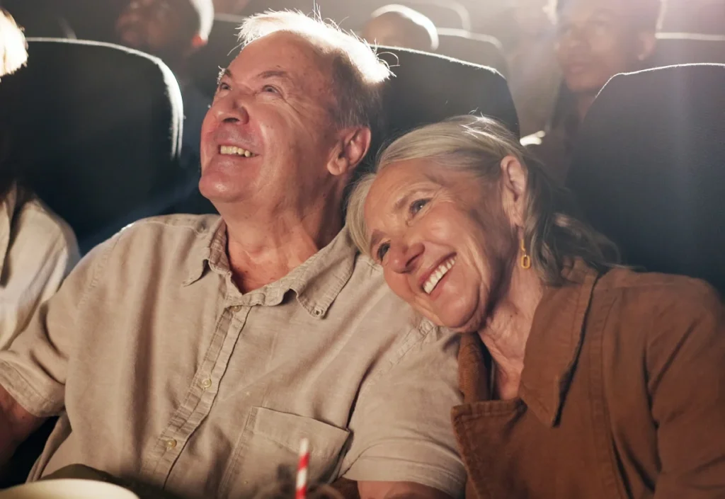 Senior couple laughing together at the movie theater