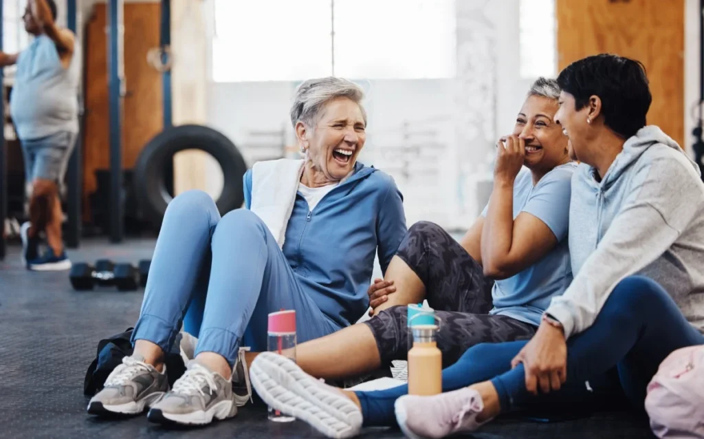 Group of senior women laughing together after a fitness class