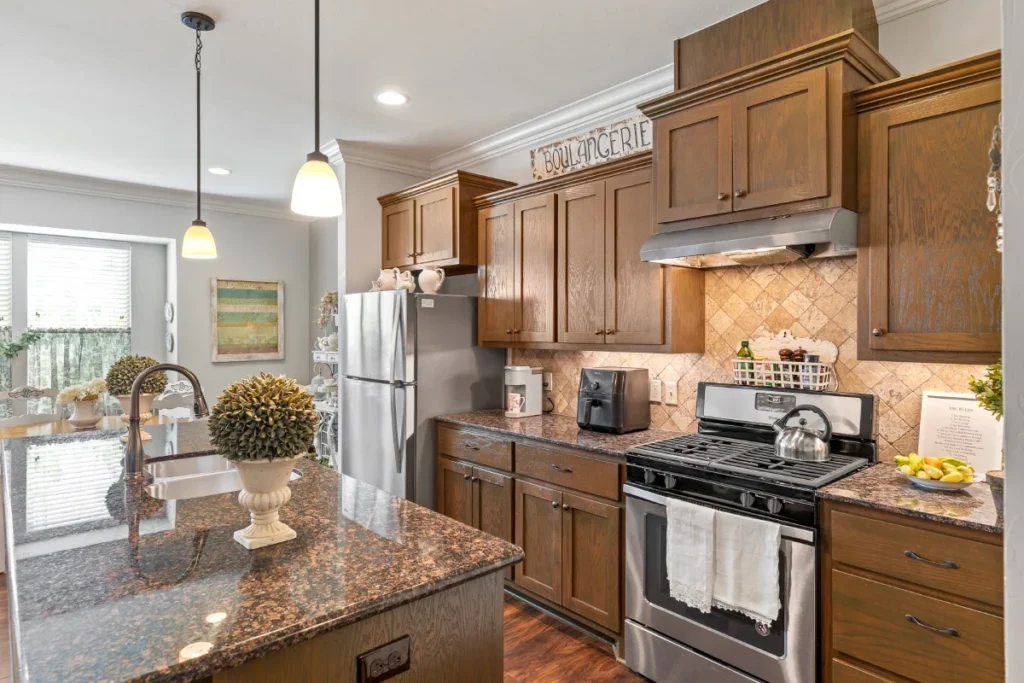 Kitchen with wooden cabinets, granite counters, stainless steel appliances and a gas stove