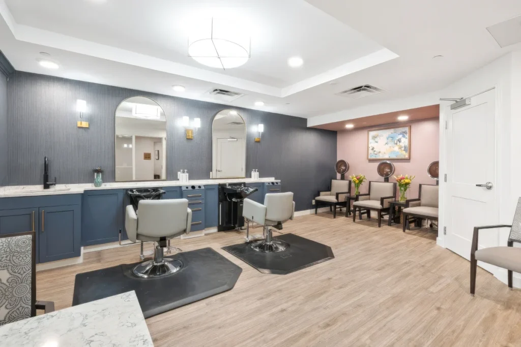 Salon room with two styling chairs, mirrors and a navy accent wall