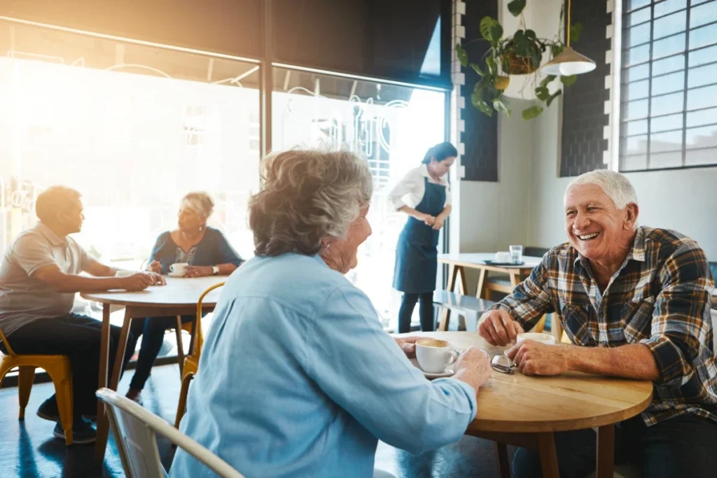 Senior couple enjoying coffee and conversation together at a cafe