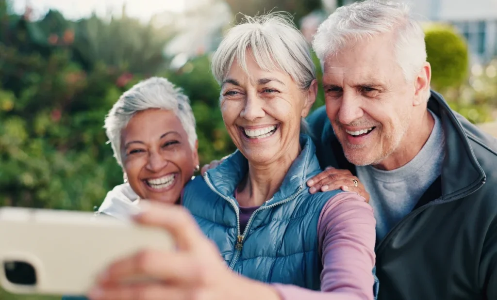 Group of senior friends taking a selfie together outdoors