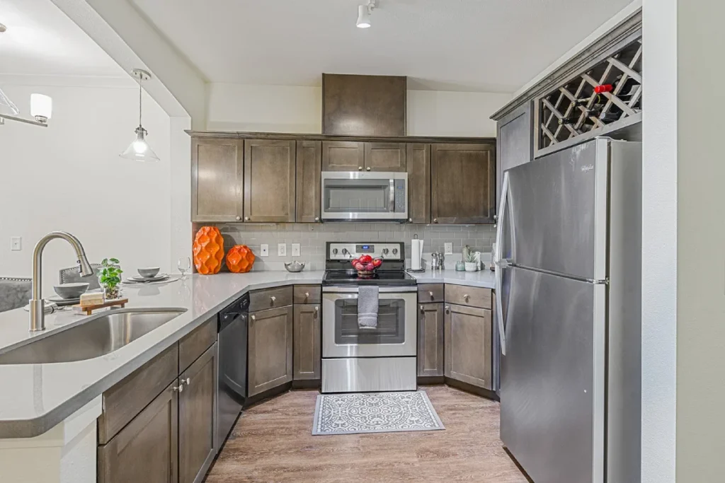 Kitchen with brown cabinets, stainless steel appliances and a wine rack