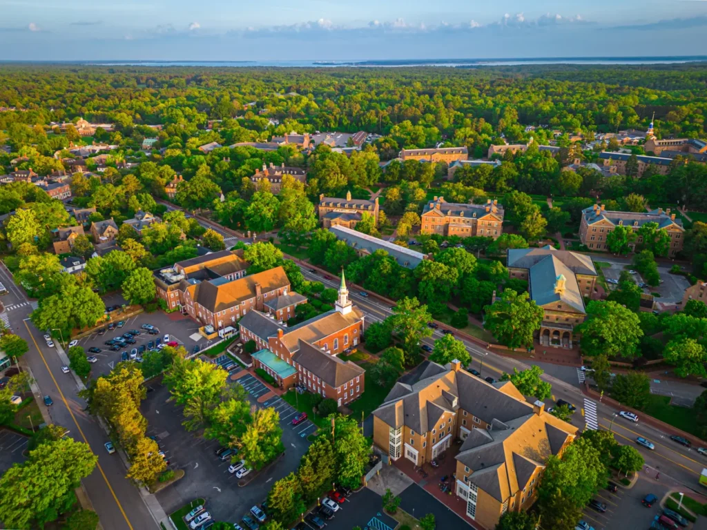 Aerial view of a small town with brick buildings, church spires and many trees