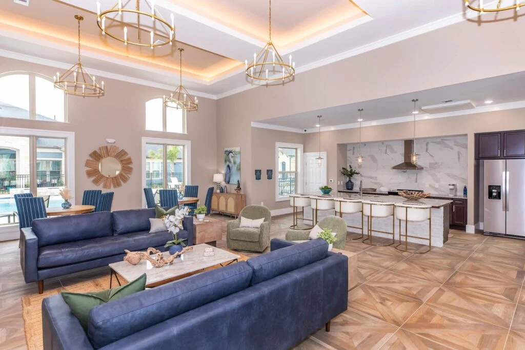 Community lounge with blue sofas and an open kitchen