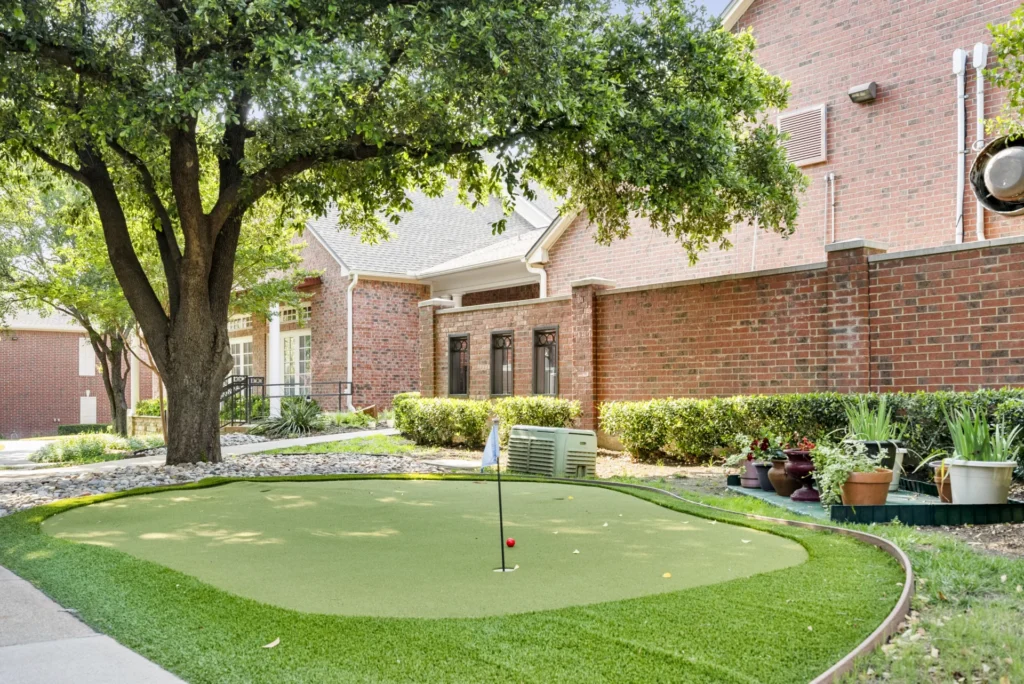 A putting green and brick building exterior