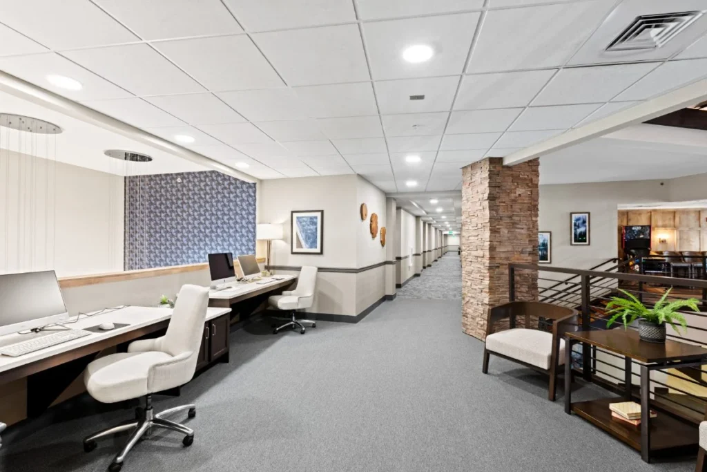 Long computer room with workstations lining a hallway