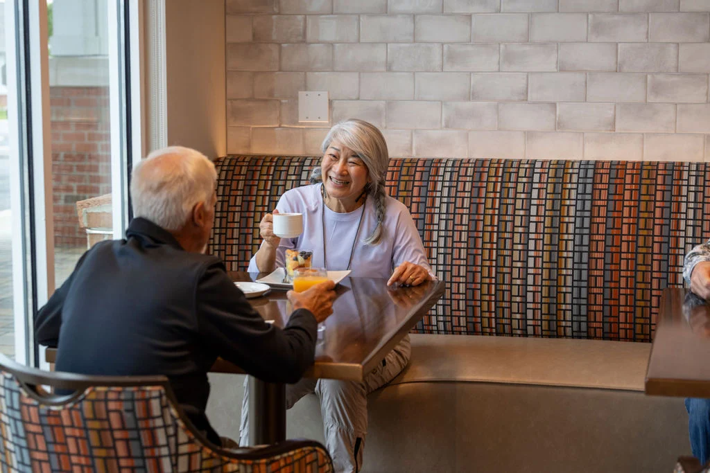 Senior couple sharing a meal in a restaurant booth