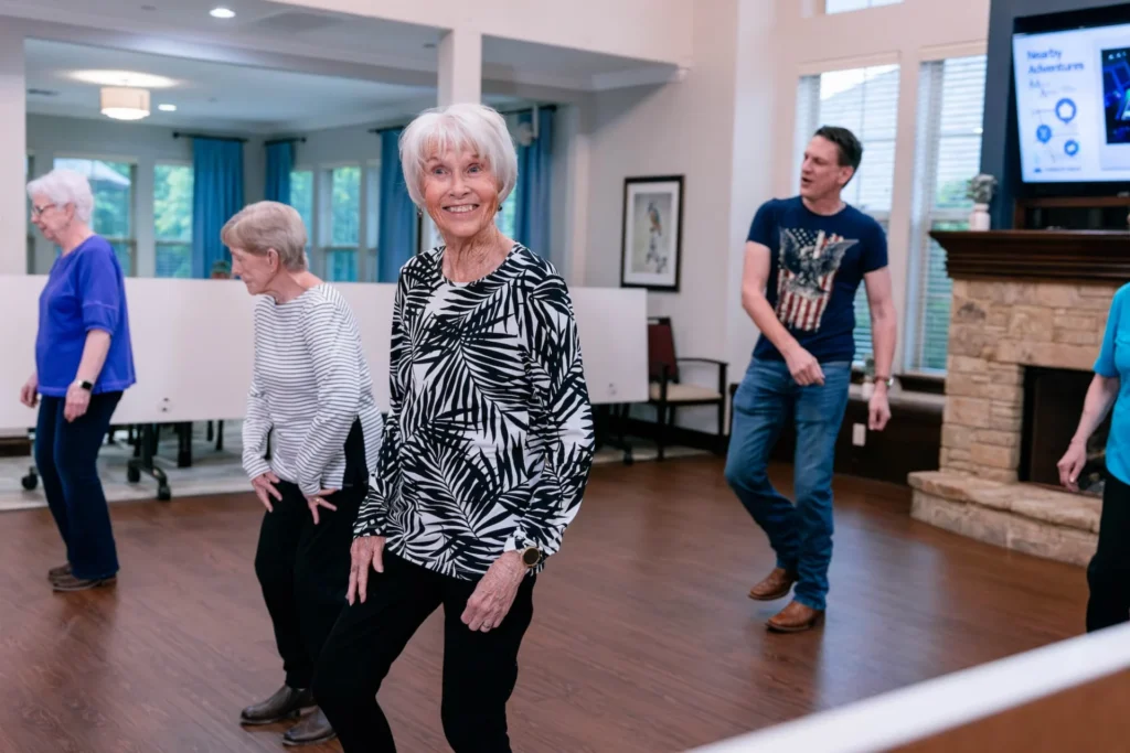 Mon Abri seniors dancing together in the activity room
