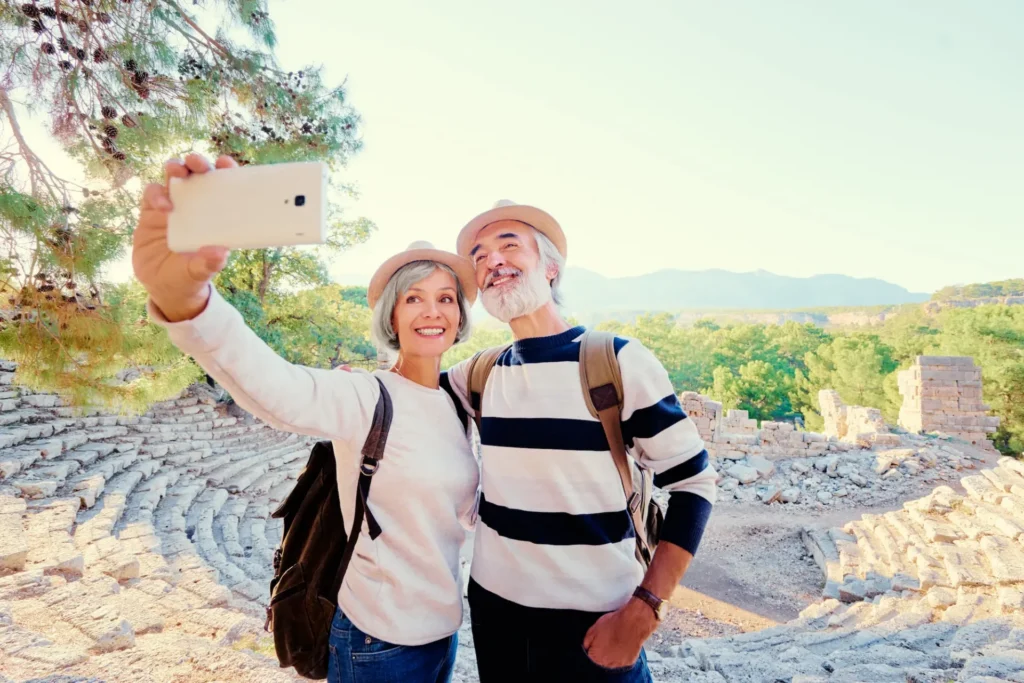 Senior man and woman taking photos while traveling