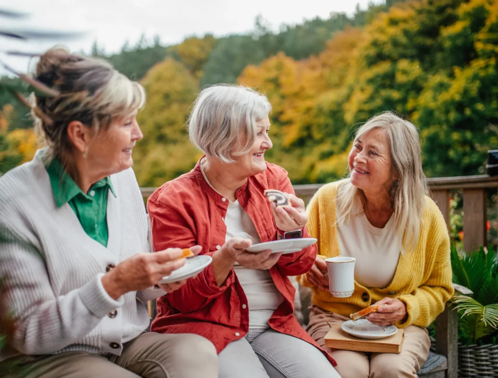 Group of senior women drinking coffee outside together