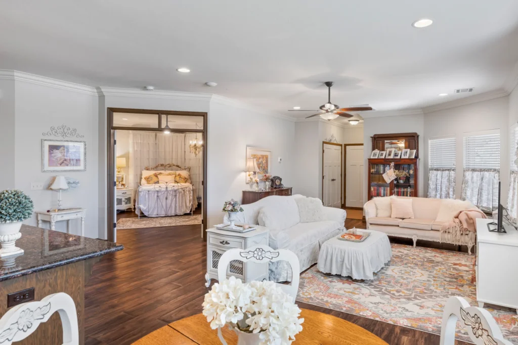 Living room with a couch and loveseat and an open doorway to the bedroom